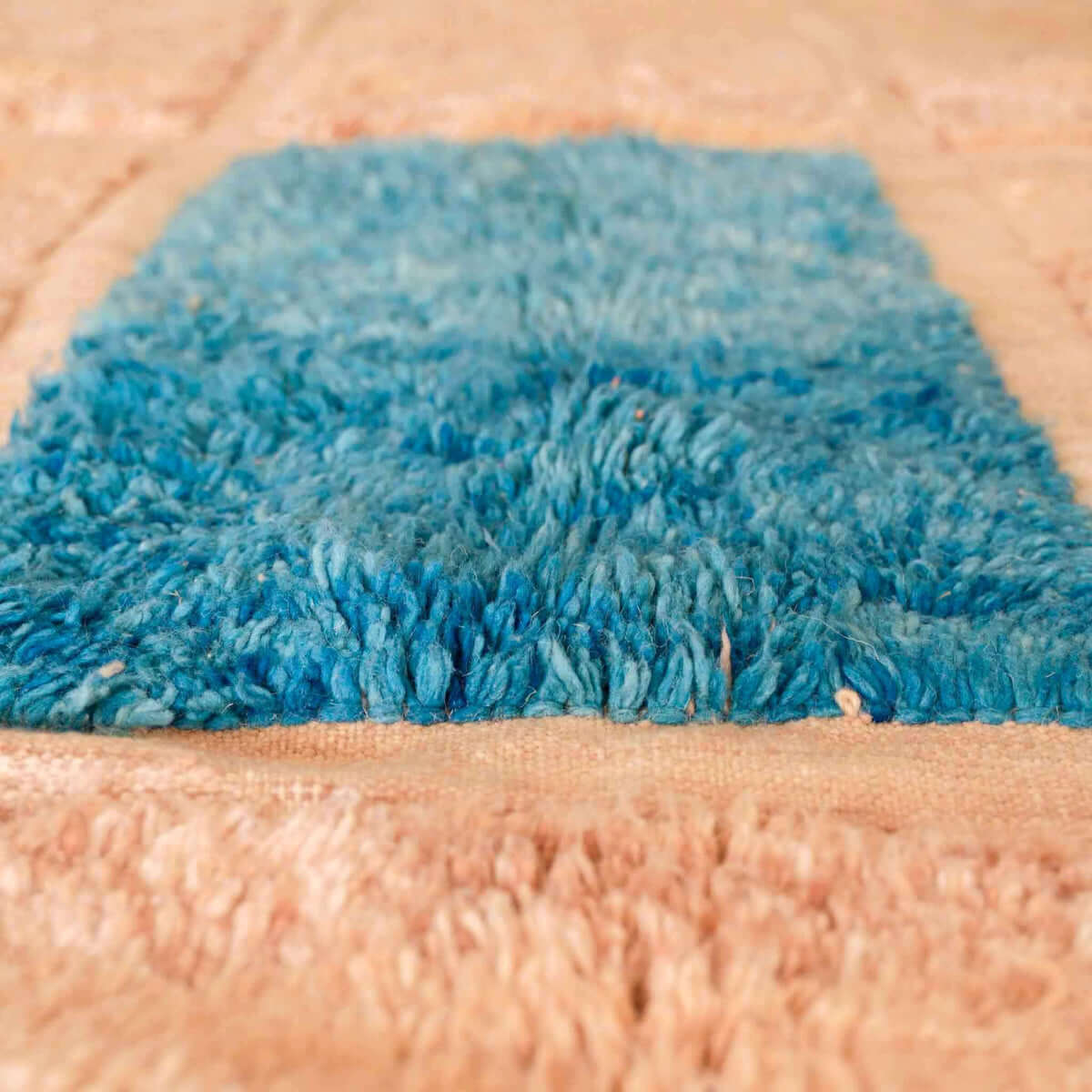 Detailed close-up of SaharaBeige rug showing plush wool texture and delicate beige motifs