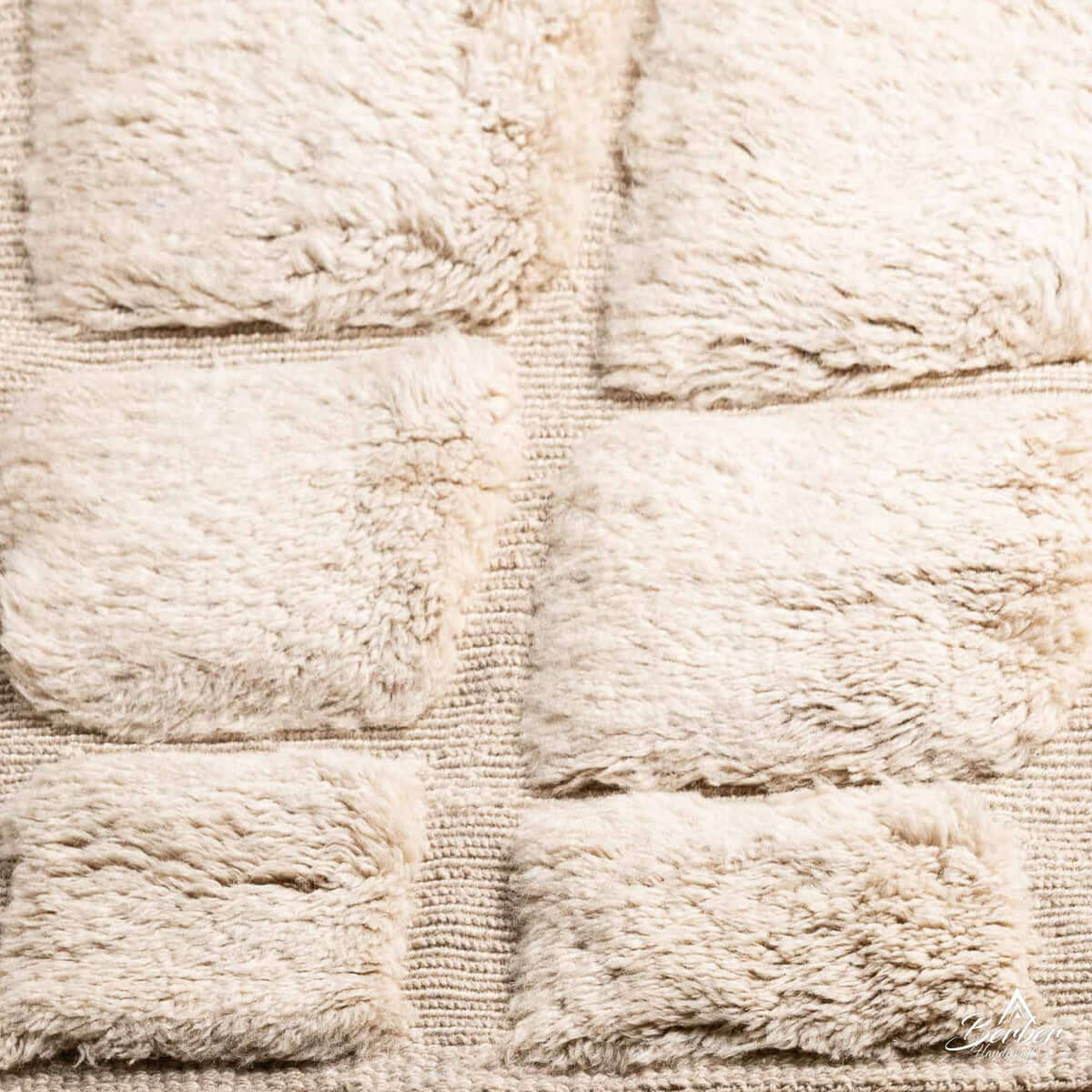 Detailed close-up of Ouraina rug showing plush wool and traditional diamond motifs