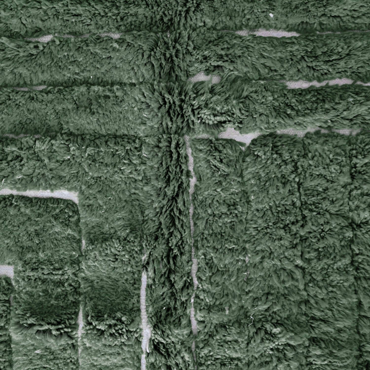 Detailed view of VerdeBer rug showing forest green wool texture and artisan knotting