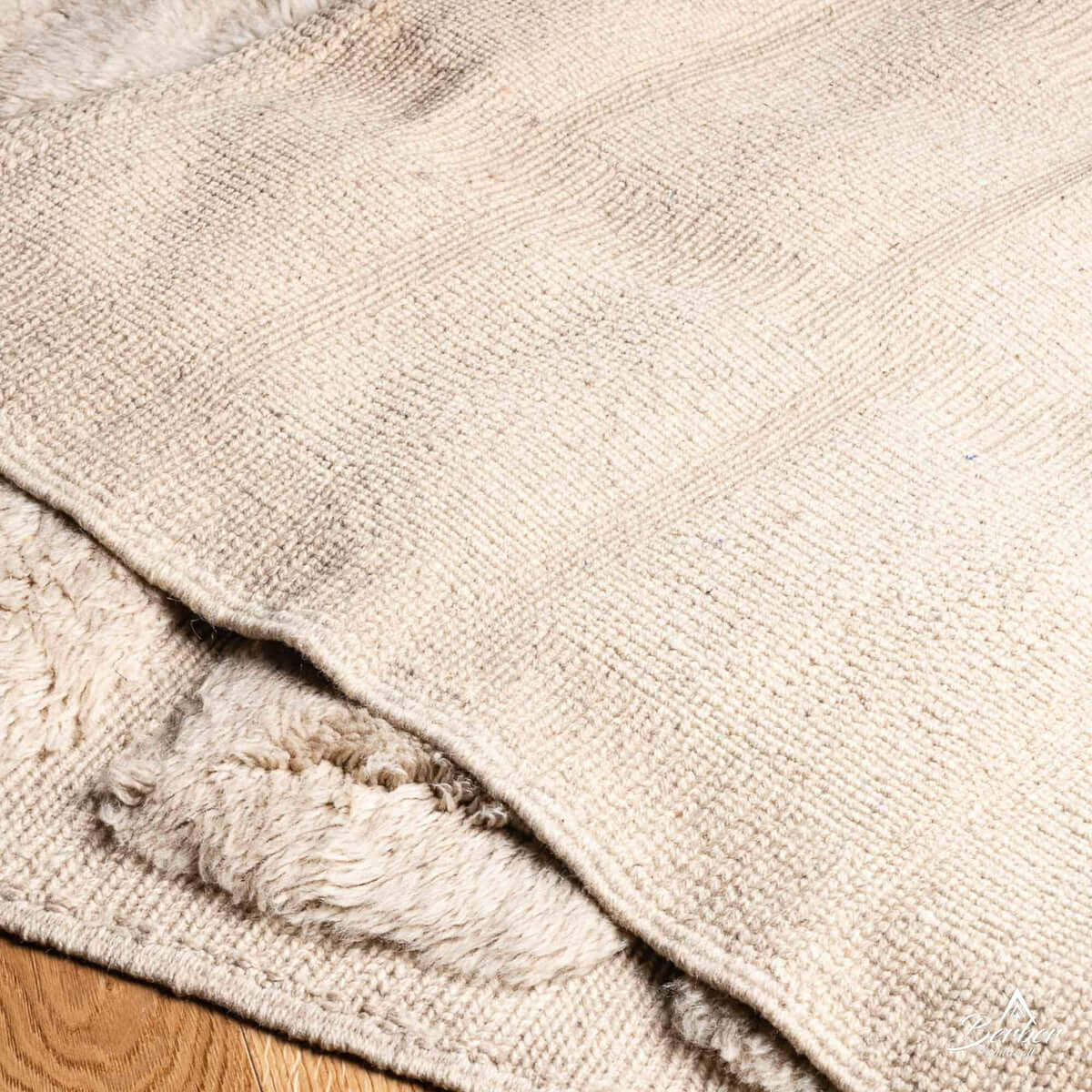 Ouraina rug edge with natural wool fringe and iconic Berber diamond design