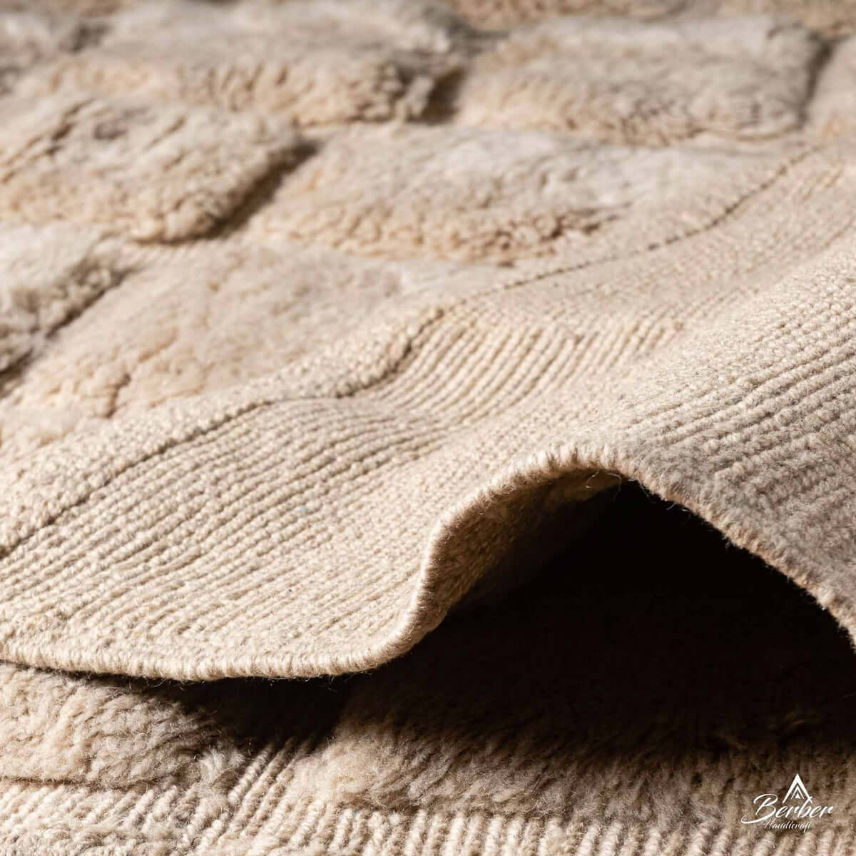 Ouraina rug edge with natural wool fringe and iconic Berber diamond design