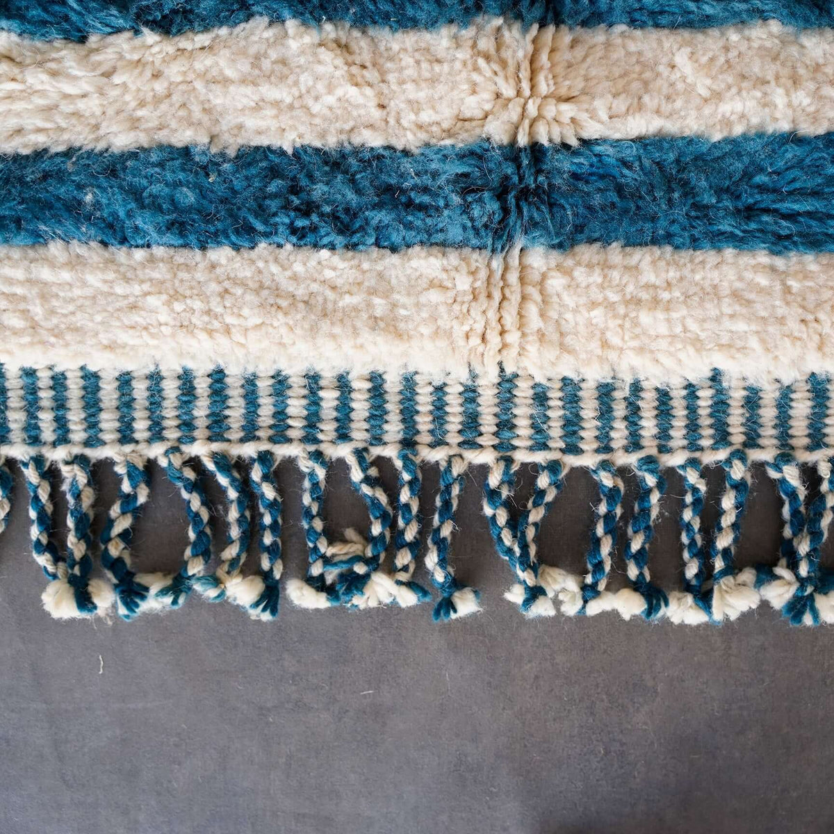 Vibraber rug border with hand-knotted fringe and vibrant multi-color tribal motifs