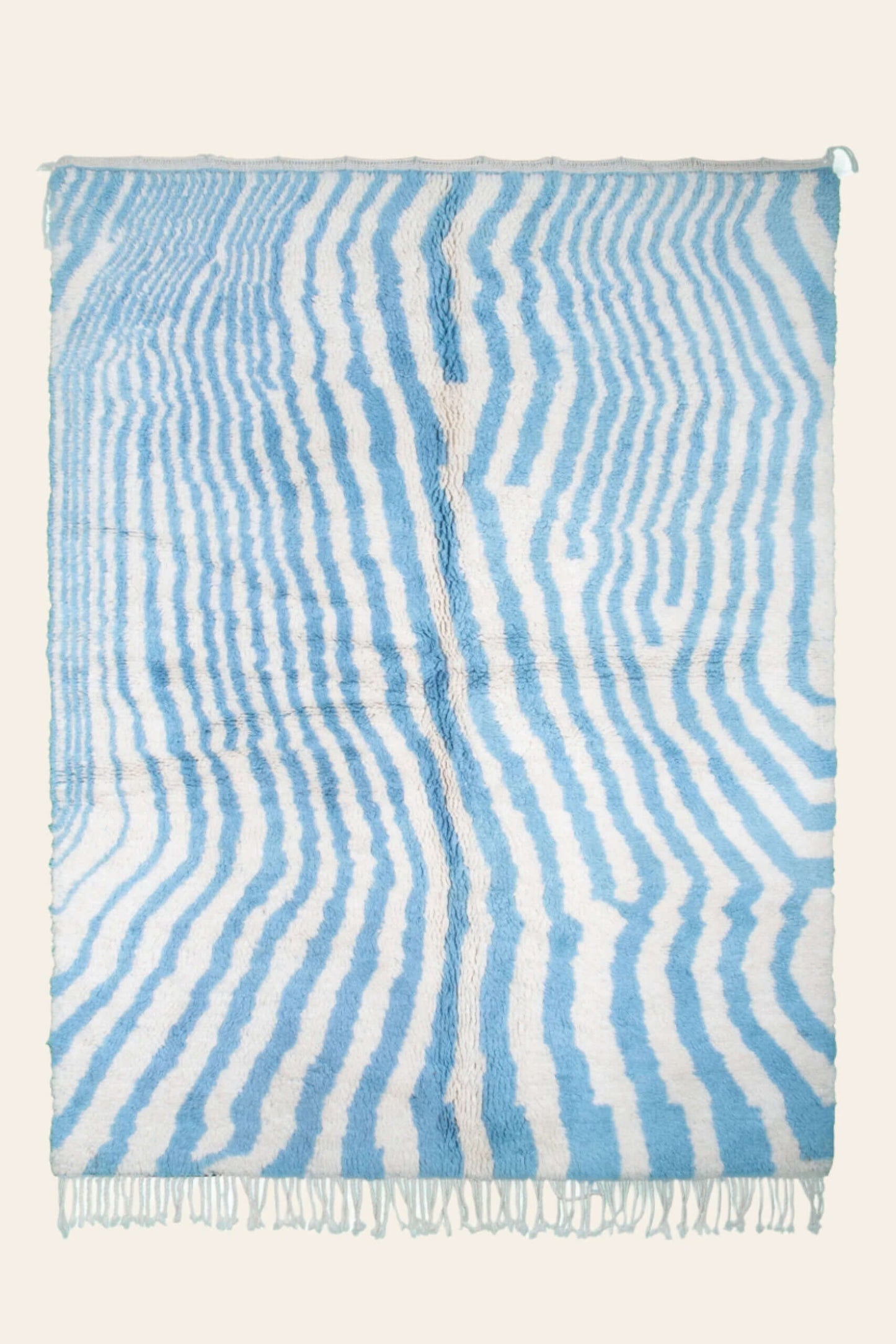 Custom Moroccan rug runner with blue and white wavy stripe Berber Moroccan rug design, handwoven from wool, featuring fringed edges for a chic Moroccan rug area.
