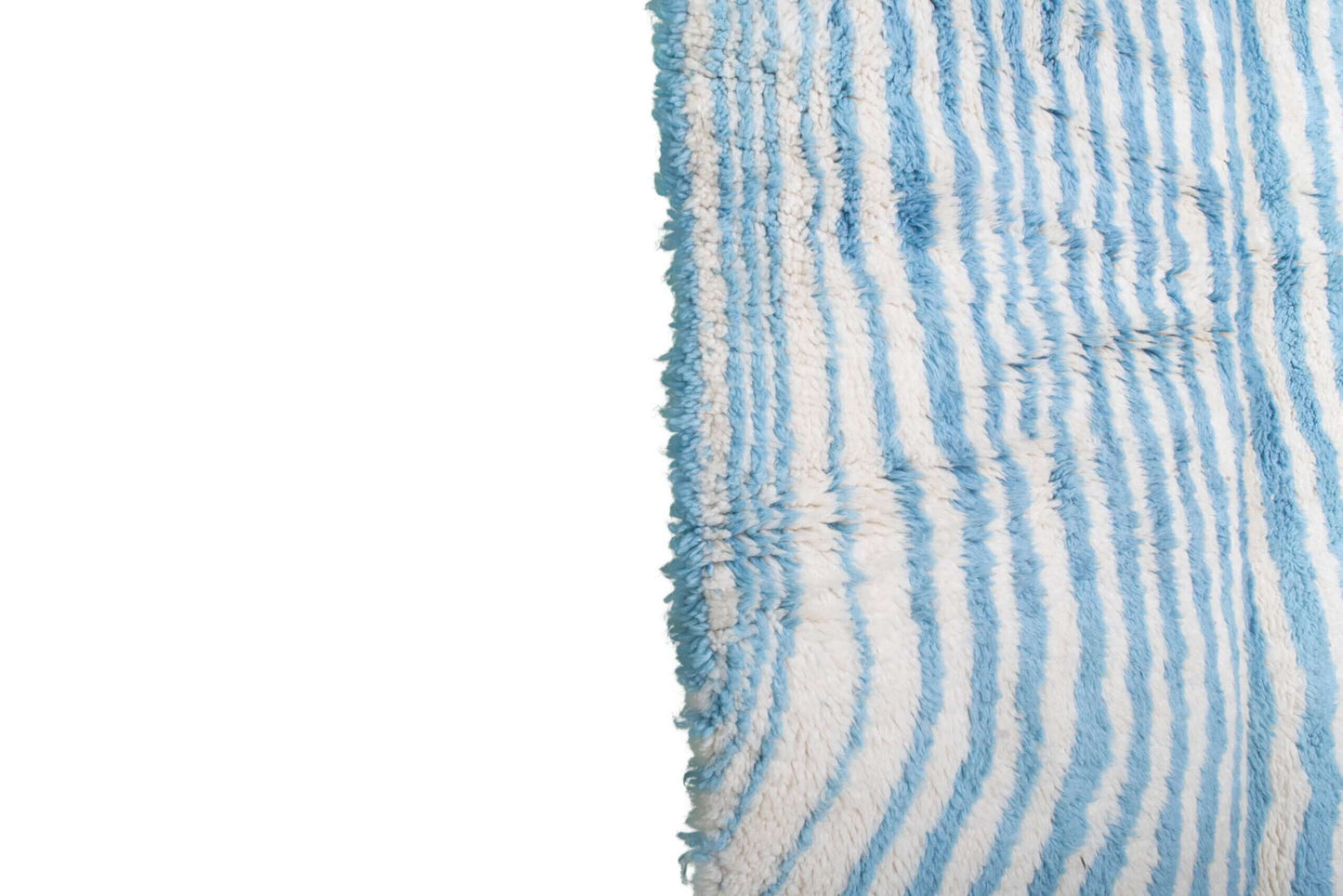 Custom Moroccan rug runner with blue and white wavy stripe Berber Moroccan rug design, handwoven from wool, featuring fringed edges for a chic Moroccan rug area.