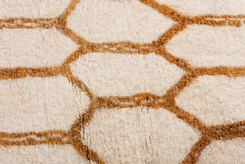 Custom Moroccan rug runner with cream base and orange hexagonal Berber Moroccan rug design, handwoven from wool, featuring fringed edges for a chic Moroccan rug area.