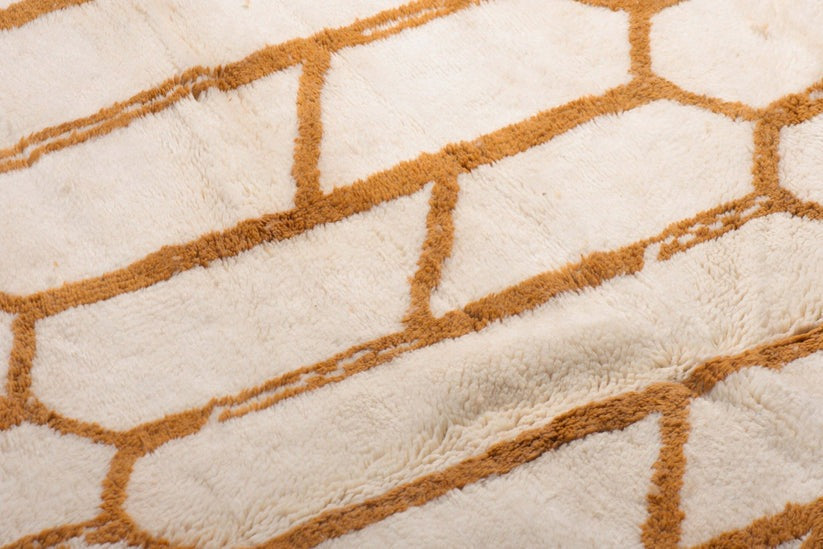 Custom Moroccan rug runner with cream base and orange hexagonal Berber Moroccan rug design, handwoven from wool, featuring fringed edges for a chic Moroccan rug area.