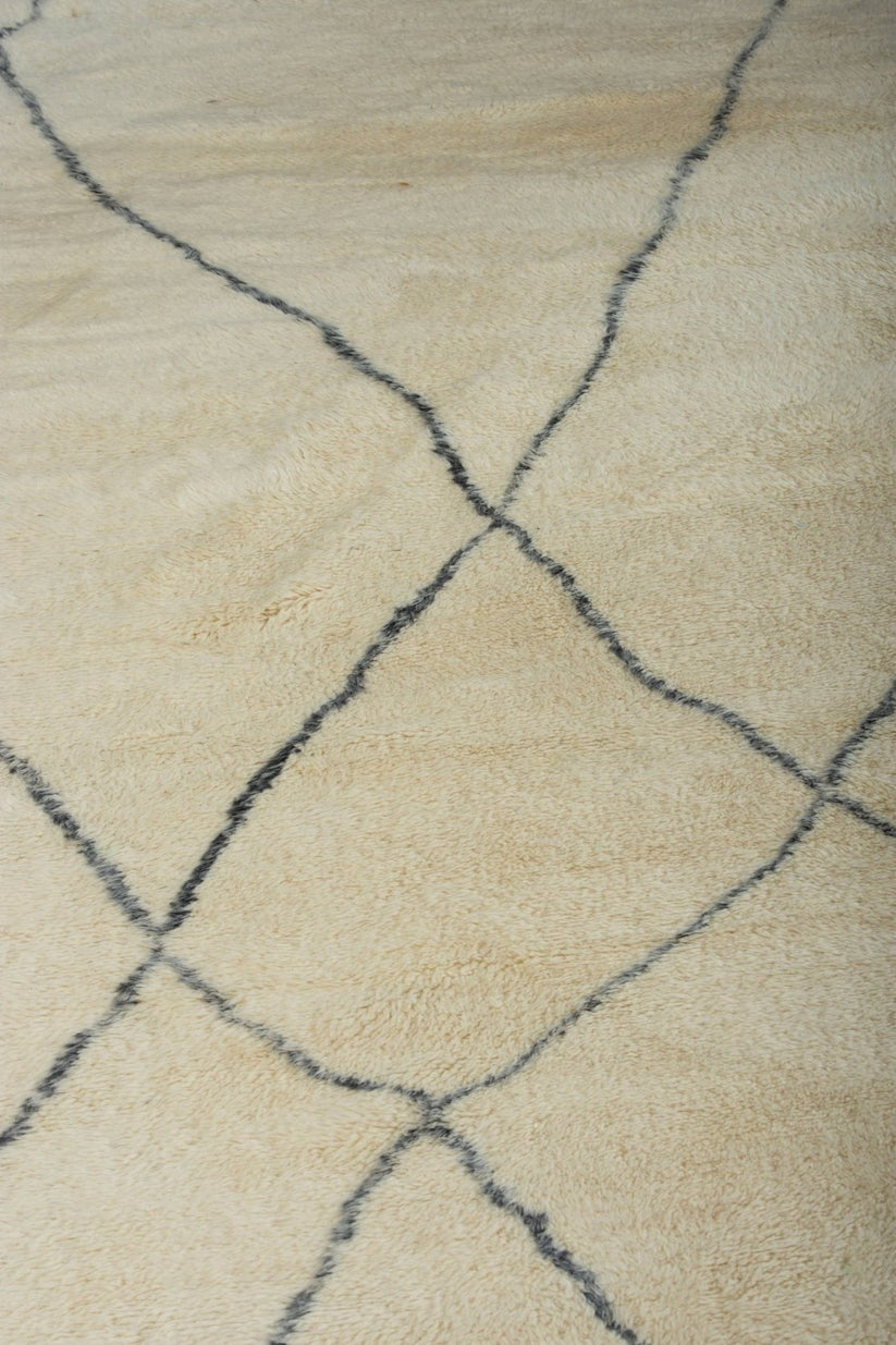 Custom Moroccan rug runner with cream base and blue diamond Berber Moroccan rug design, handwoven from wool, featuring fringed edges for a chic Moroccan rug area.