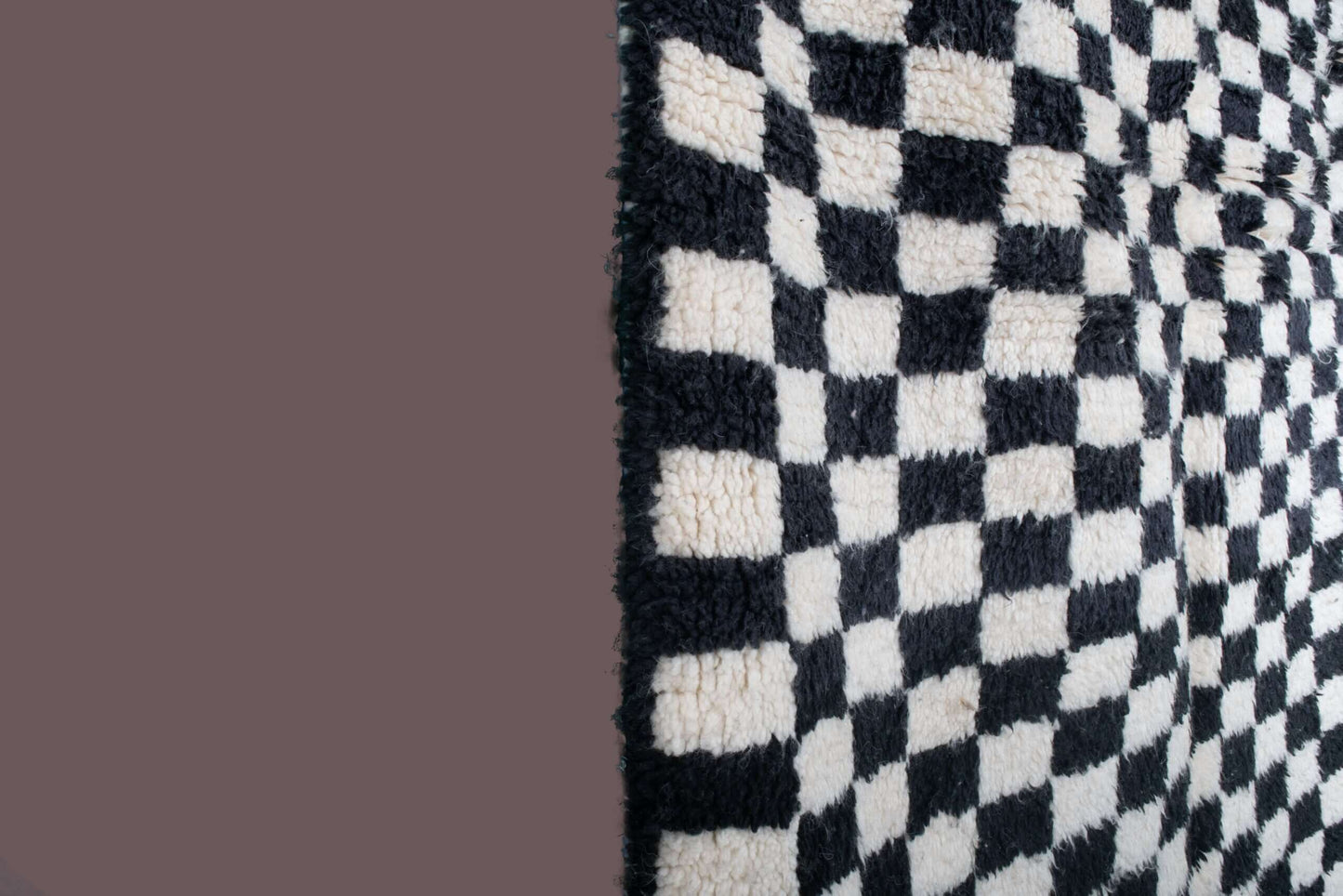 Custom Moroccan rug runner with black and white checkered Berber Moroccan rug design, handwoven from wool, featuring fringed edges for a striking Moroccan rug area.