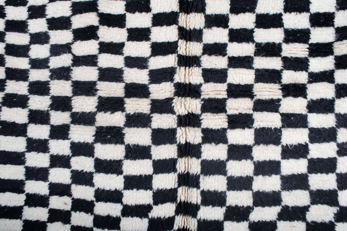 Custom Moroccan rug runner with black and white checkered Berber Moroccan rug design, handwoven from wool, featuring fringed edges for a striking Moroccan rug area.