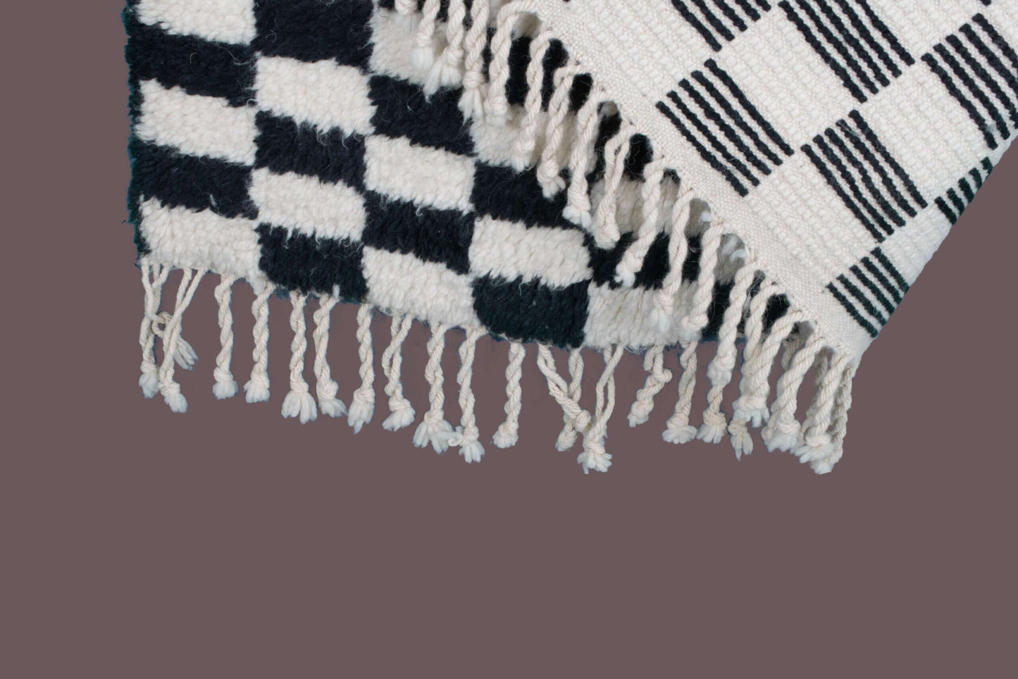Custom Moroccan rug runner with black and white checkered Berber Moroccan rug design, handwoven from wool, featuring fringed edges for a striking Moroccan rug area.