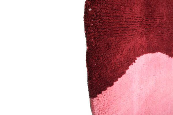 Custom Moroccan rug runner with pink and burgundy Berber Moroccan rug design, handwoven from wool, featuring fringed edges for a cozy Moroccan rug area.