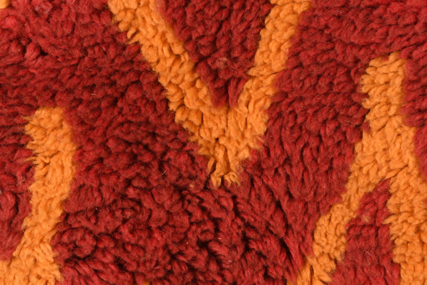 Custom Moroccan rug runner with red base and orange zigzag Berber Moroccan rug design, handwoven from wool, featuring fringed edges for a stylish Moroccan rug area.