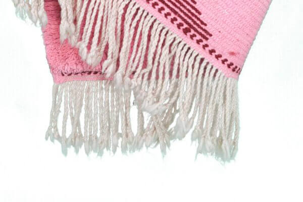 Custom Moroccan rug runner with pink and burgundy Berber Moroccan rug design, handwoven from wool, featuring fringed edges for a cozy Moroccan rug area.