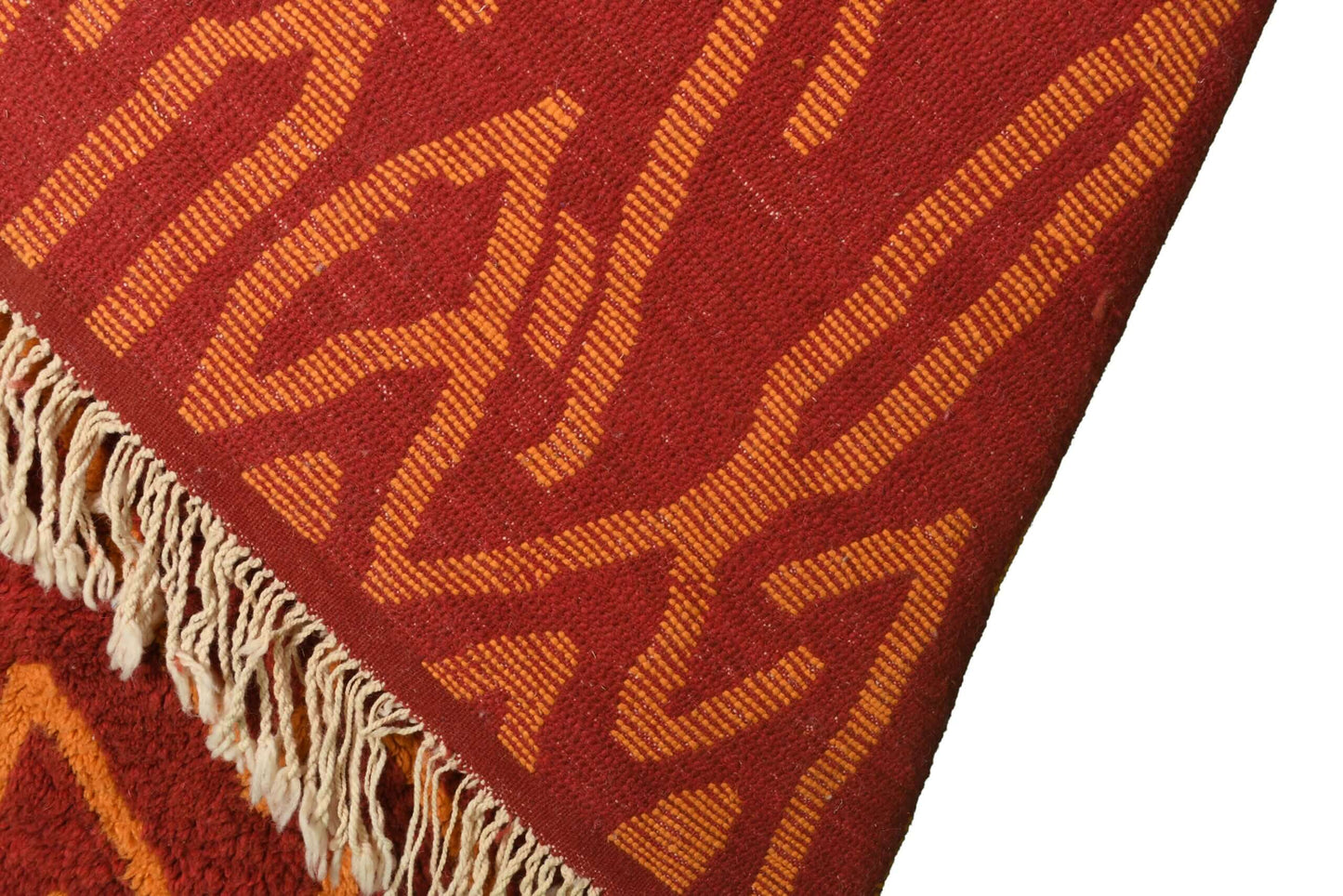 Custom Moroccan rug runner with red base and orange zigzag Berber Moroccan rug design, handwoven from wool, featuring fringed edges for a stylish Moroccan rug area.