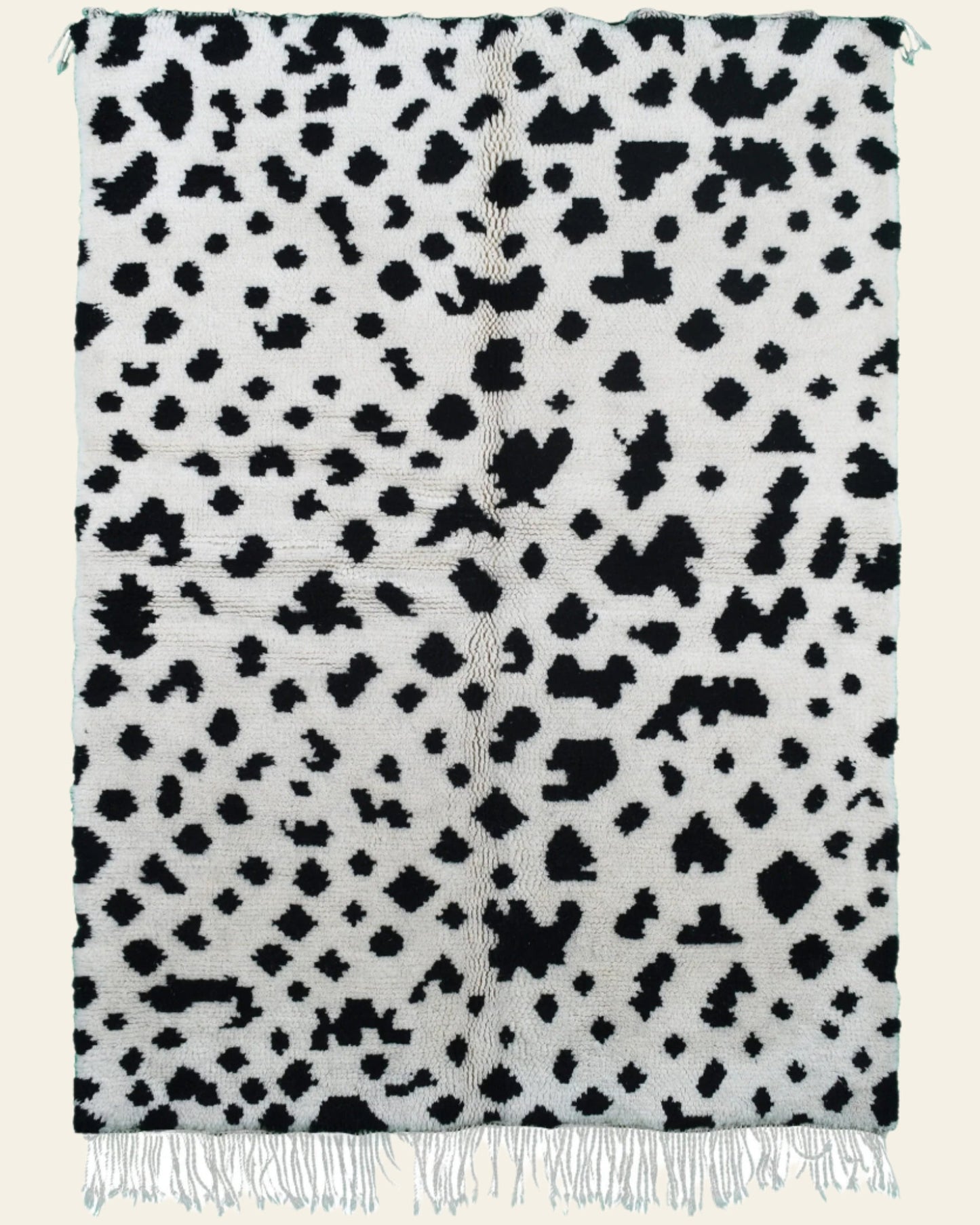 Custom Moroccan rug runner with white base and scattered black abstract Berber Moroccan rug design, handwoven from wool, featuring fringed edges for a unique Moroccan rug area.