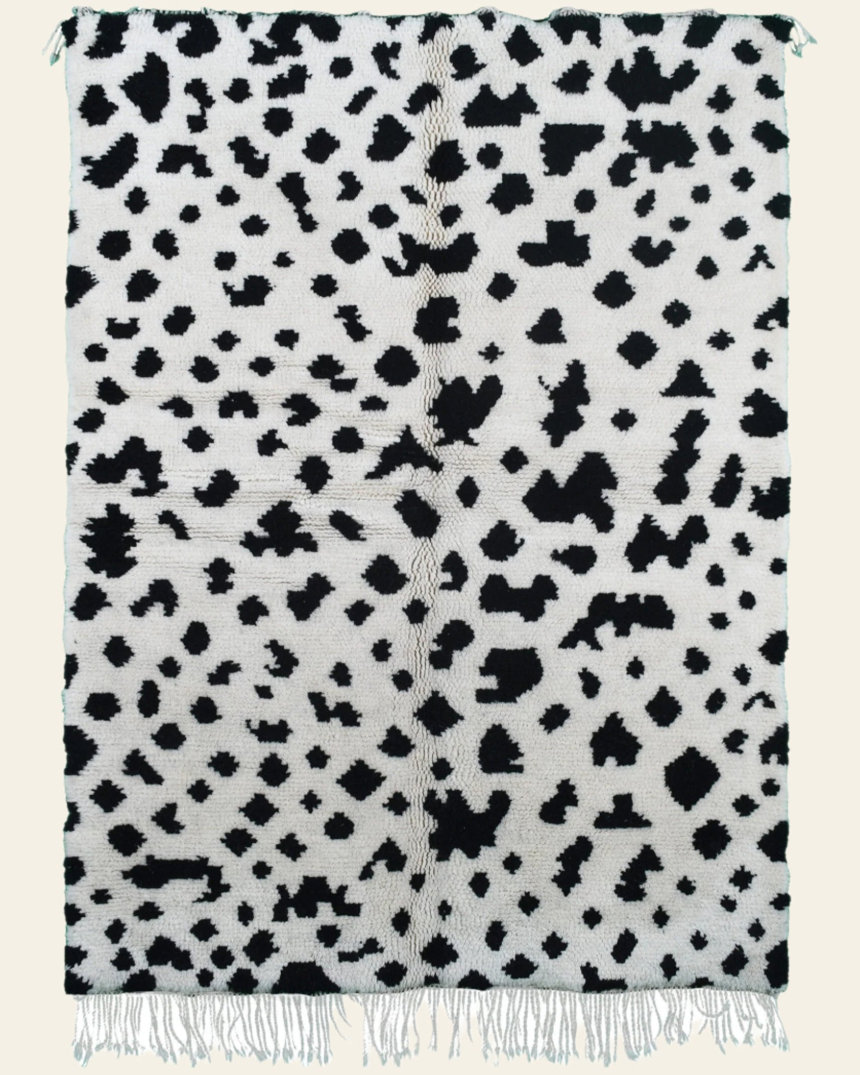 Custom Moroccan rug runner with white base and scattered black abstract Berber Moroccan rug design, handwoven from wool, featuring fringed edges for a unique Moroccan rug area.