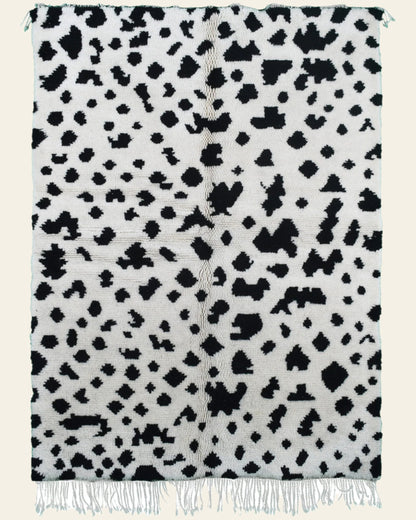 Custom Moroccan rug runner with white base and scattered black abstract Berber Moroccan rug design, handwoven from wool, featuring fringed edges for a unique Moroccan rug area.