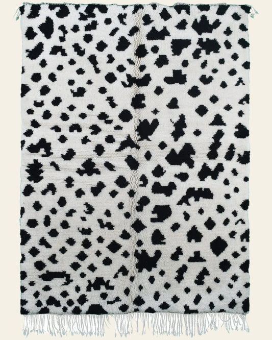 Custom Moroccan rug runner with white base and scattered black abstract Berber Moroccan rug design, handwoven from wool, featuring fringed edges for a unique Moroccan rug area.