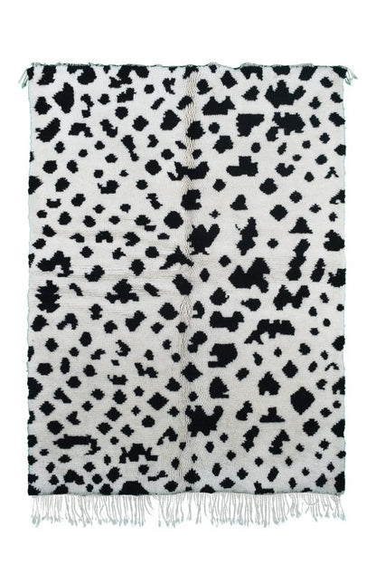 Custom Moroccan rug runner with white base and scattered black abstract Berber Moroccan rug design, handwoven from wool, featuring fringed edges for a unique Moroccan rug area.