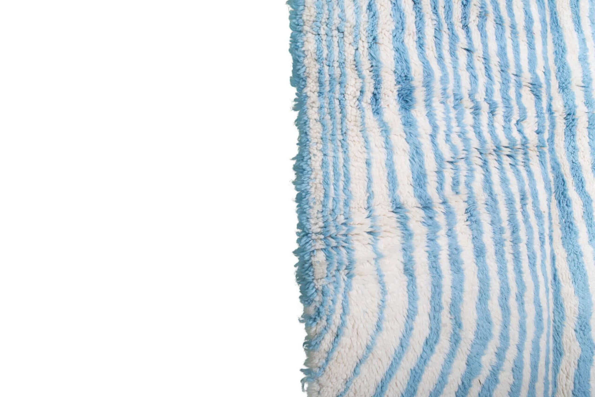 Custom Moroccan rug runner with blue and white wavy stripe Berber Moroccan rug design, handwoven from wool, featuring fringed edges for a chic Moroccan rug area.