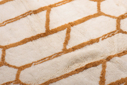 Custom Moroccan rug runner with cream base and orange hexagonal Berber Moroccan rug design, handwoven from wool, featuring fringed edges for a chic Moroccan rug area.