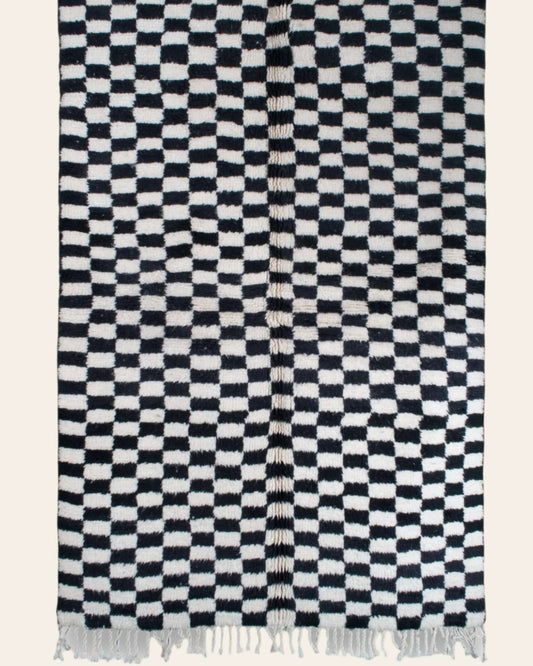 Custom Moroccan rug runner with black and white checkered Berber Moroccan rug design, handwoven from wool, featuring fringed edges for a striking Moroccan rug area.