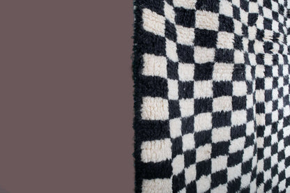 Custom Moroccan rug runner with black and white checkered Berber Moroccan rug design, handwoven from wool, featuring fringed edges for a striking Moroccan rug area.