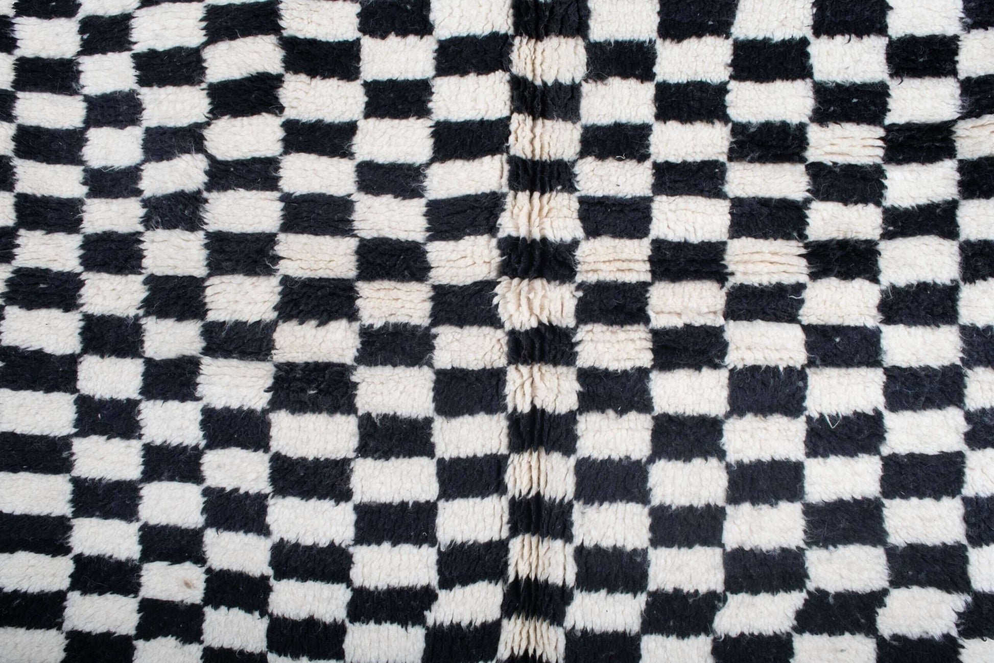 Custom Moroccan rug runner with black and white checkered Berber Moroccan rug design, handwoven from wool, featuring fringed edges for a striking Moroccan rug area.