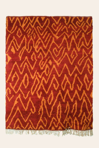 Custom Moroccan rug runner with red base and orange zigzag Berber Moroccan rug design, handwoven from wool, featuring fringed edges for a stylish Moroccan rug area.