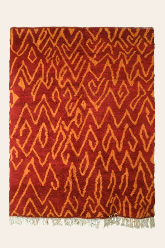 Custom Moroccan rug runner with red base and orange zigzag Berber Moroccan rug design, handwoven from wool, featuring fringed edges for a stylish Moroccan rug area.