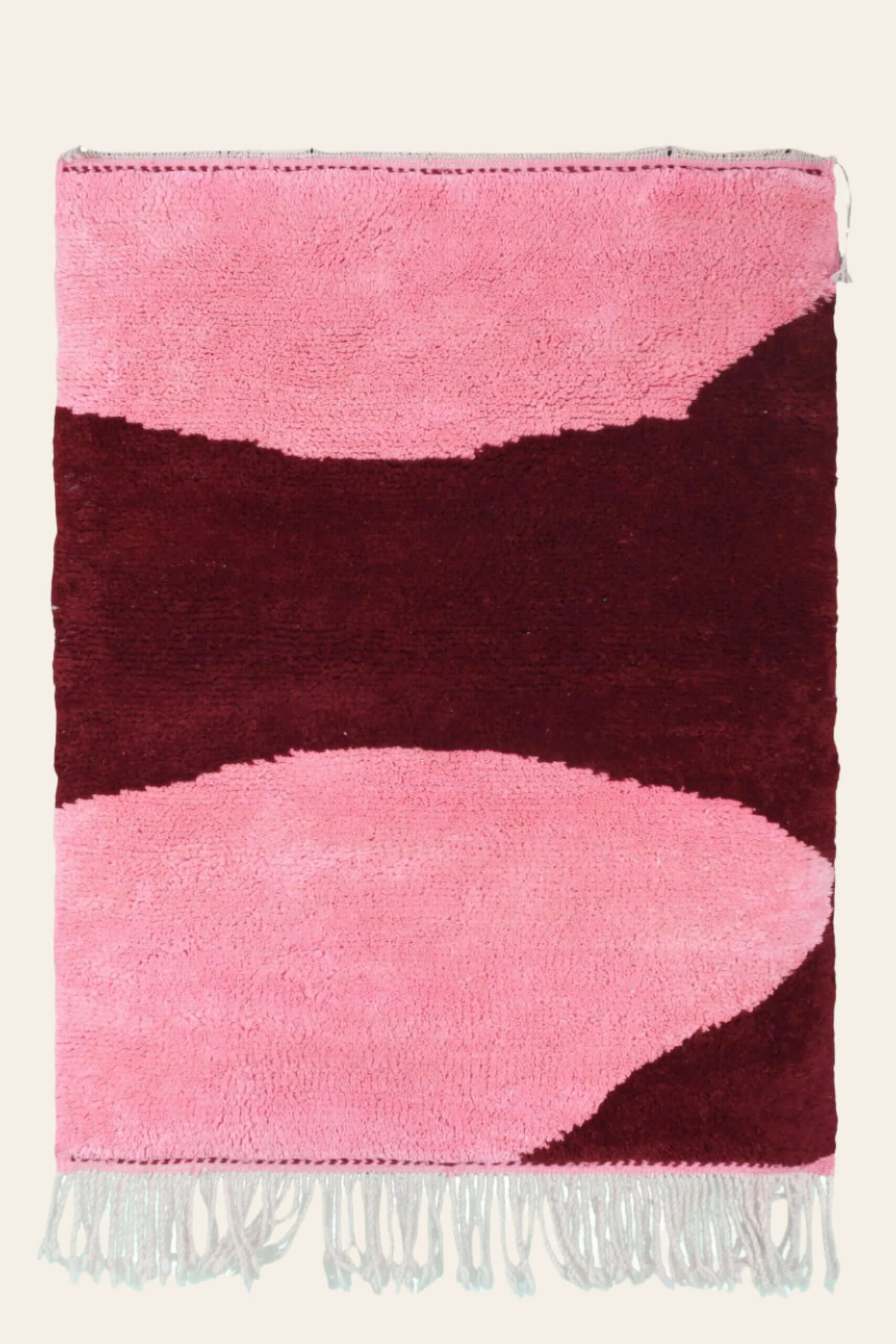 Custom Moroccan rug runner with pink and burgundy Berber Moroccan rug design, handwoven from wool, featuring fringed edges for a cozy Moroccan rug area.